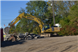 Excavator moving pieces of concrete