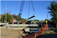 Bridge support beam being moved into position