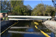 Bridge support beam being lowered into position