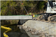 Bridge support beam almost into position on north end of bridge