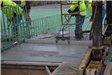 Worker leveling concrete