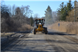 Front View of Grader Grading on Livernois Road Near Dutton Road