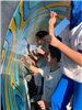 Close Up Side View of Students Painting the Plow
