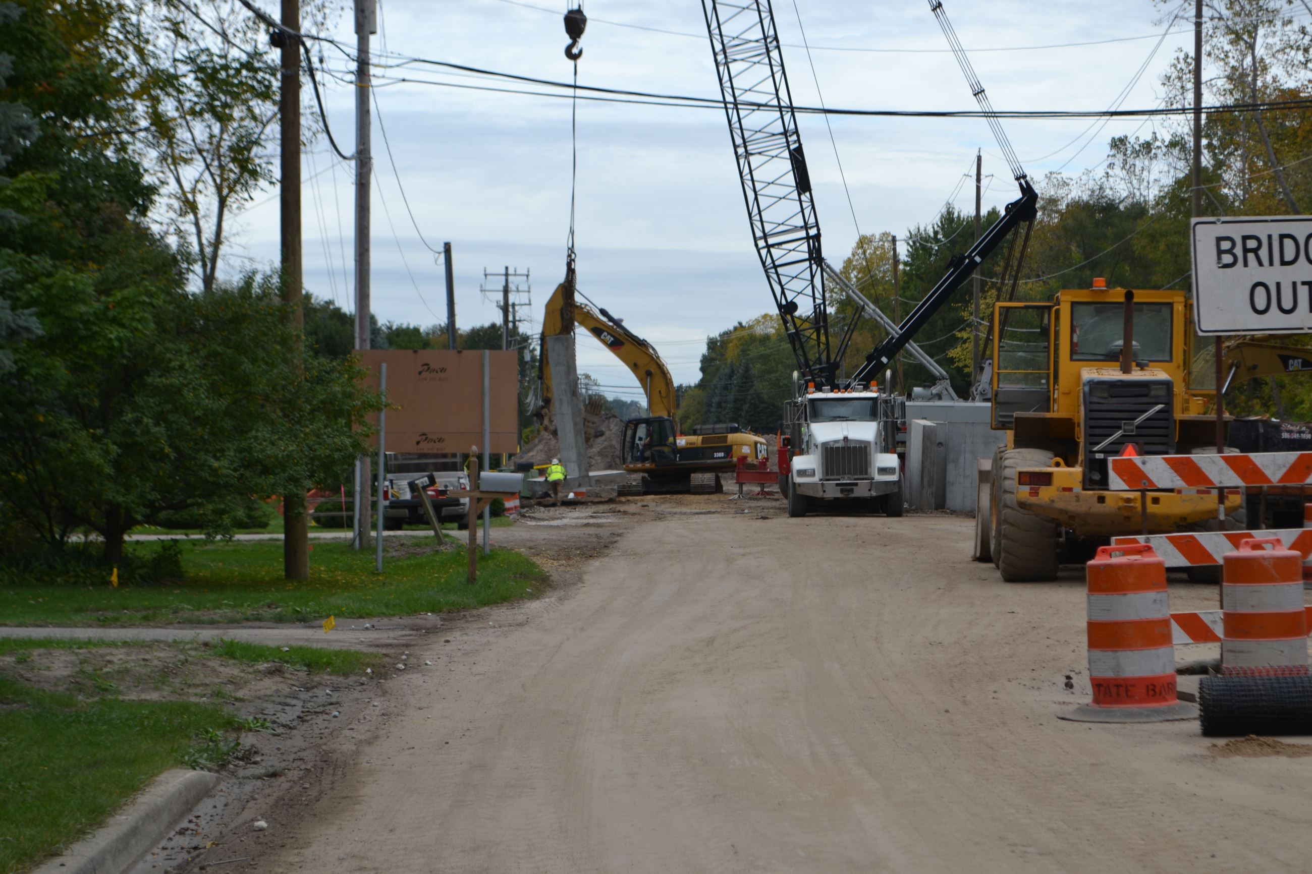 Crane lowering wing wall into place