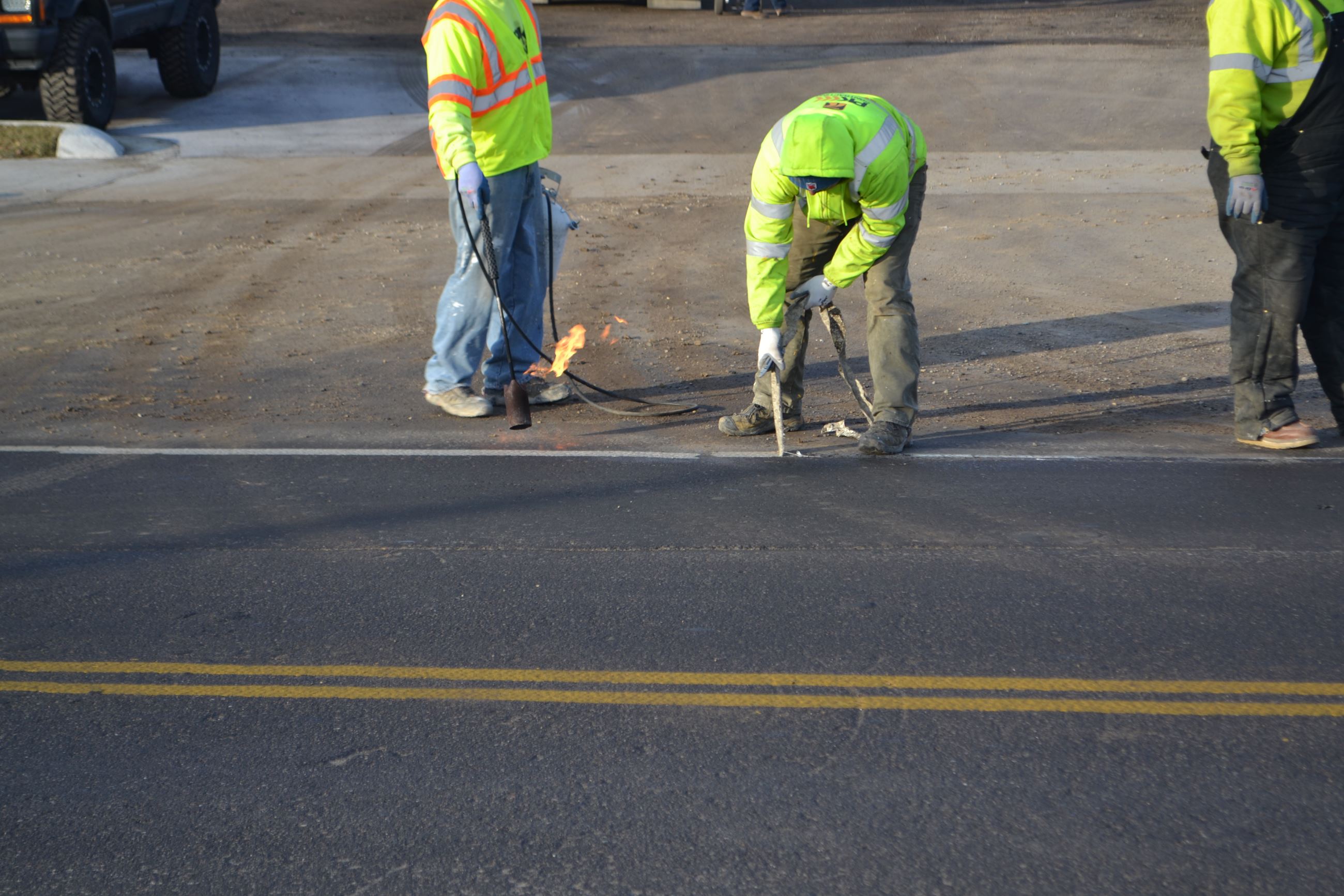 Striping Crew Removing Old Striping