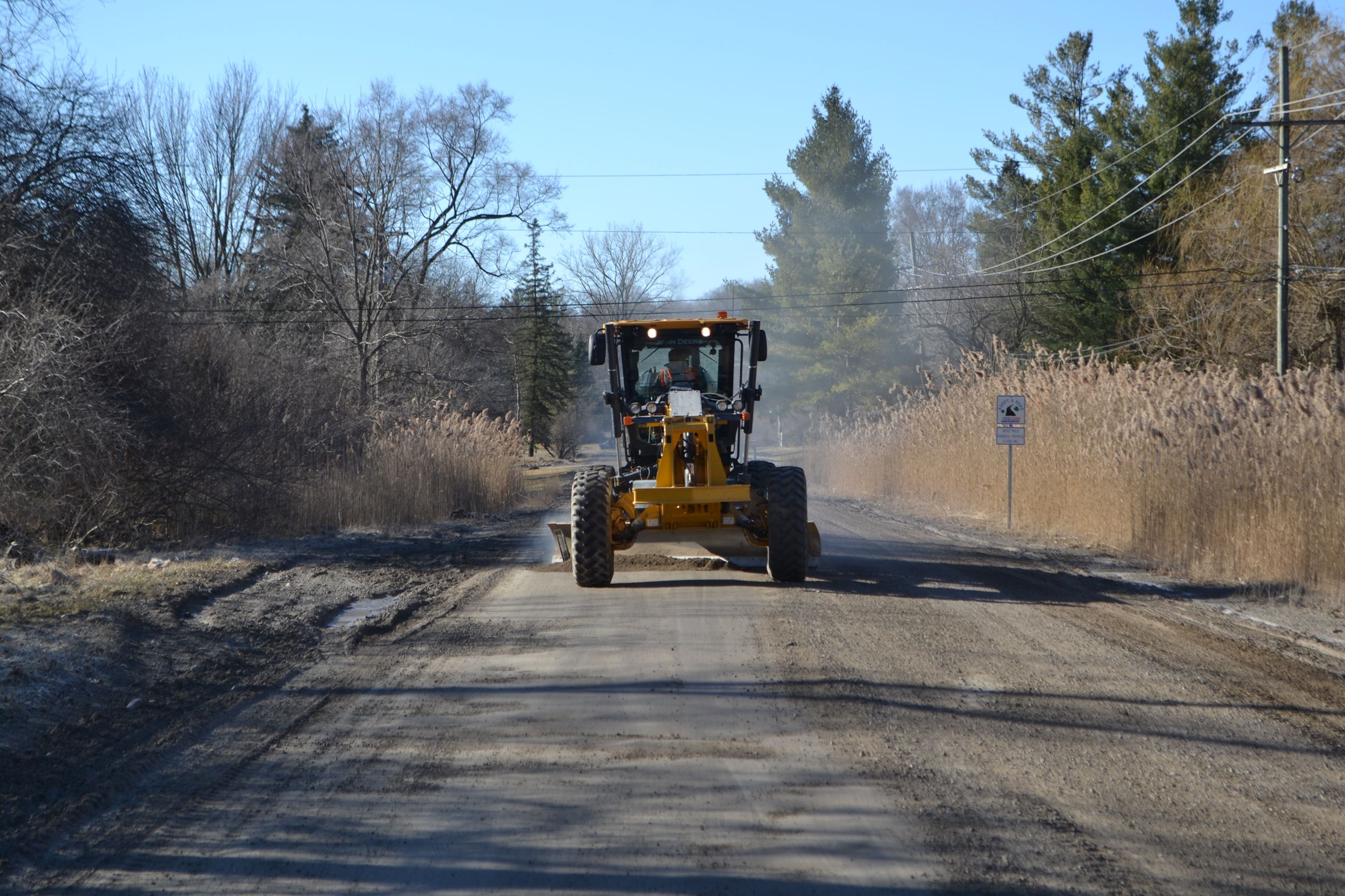 Front View of Grader Grading on Livernois Road Near Dutton Road