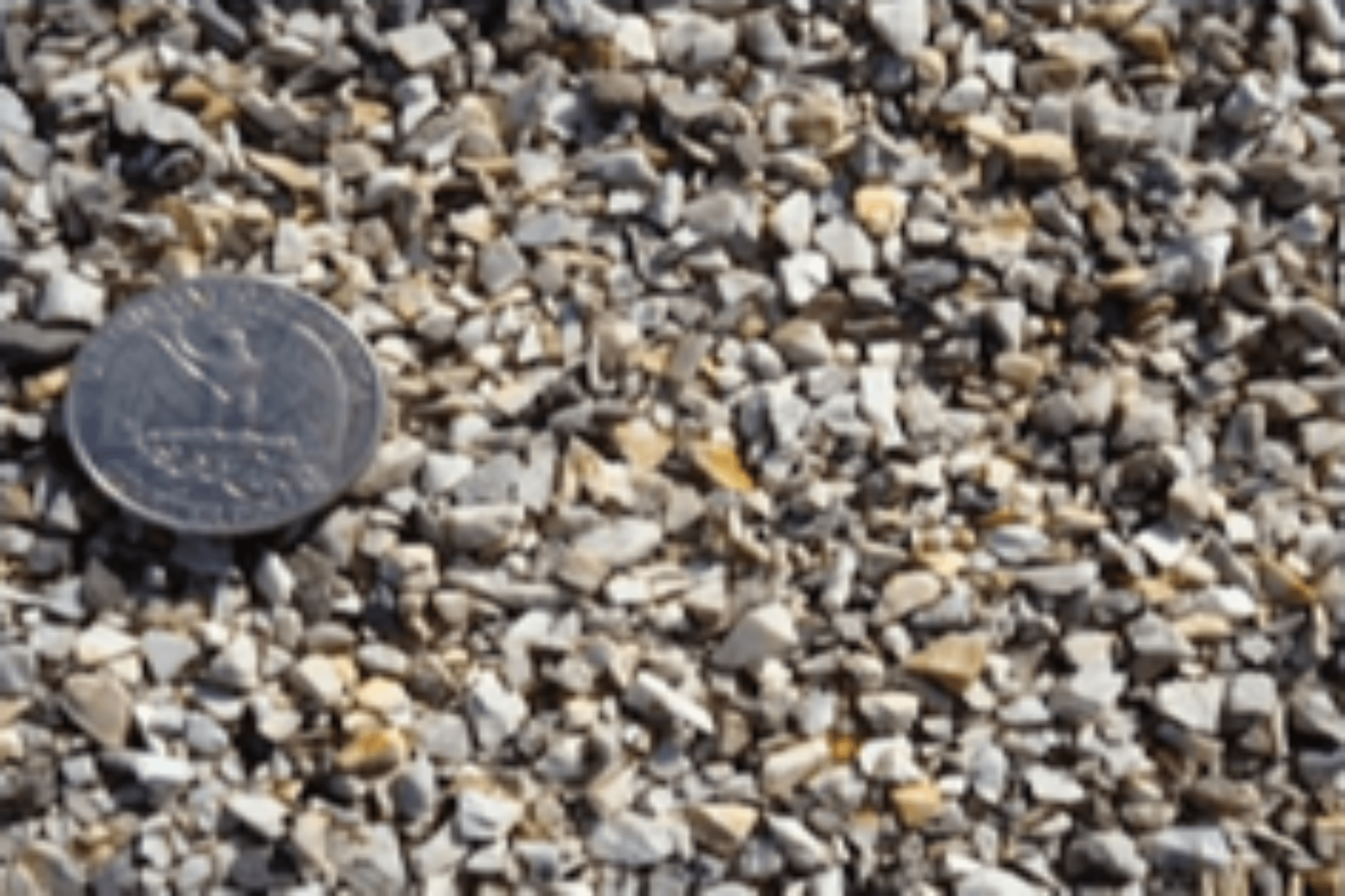 High Friction Surface Treatment photo of bauxite stone and quarter on road treated surface