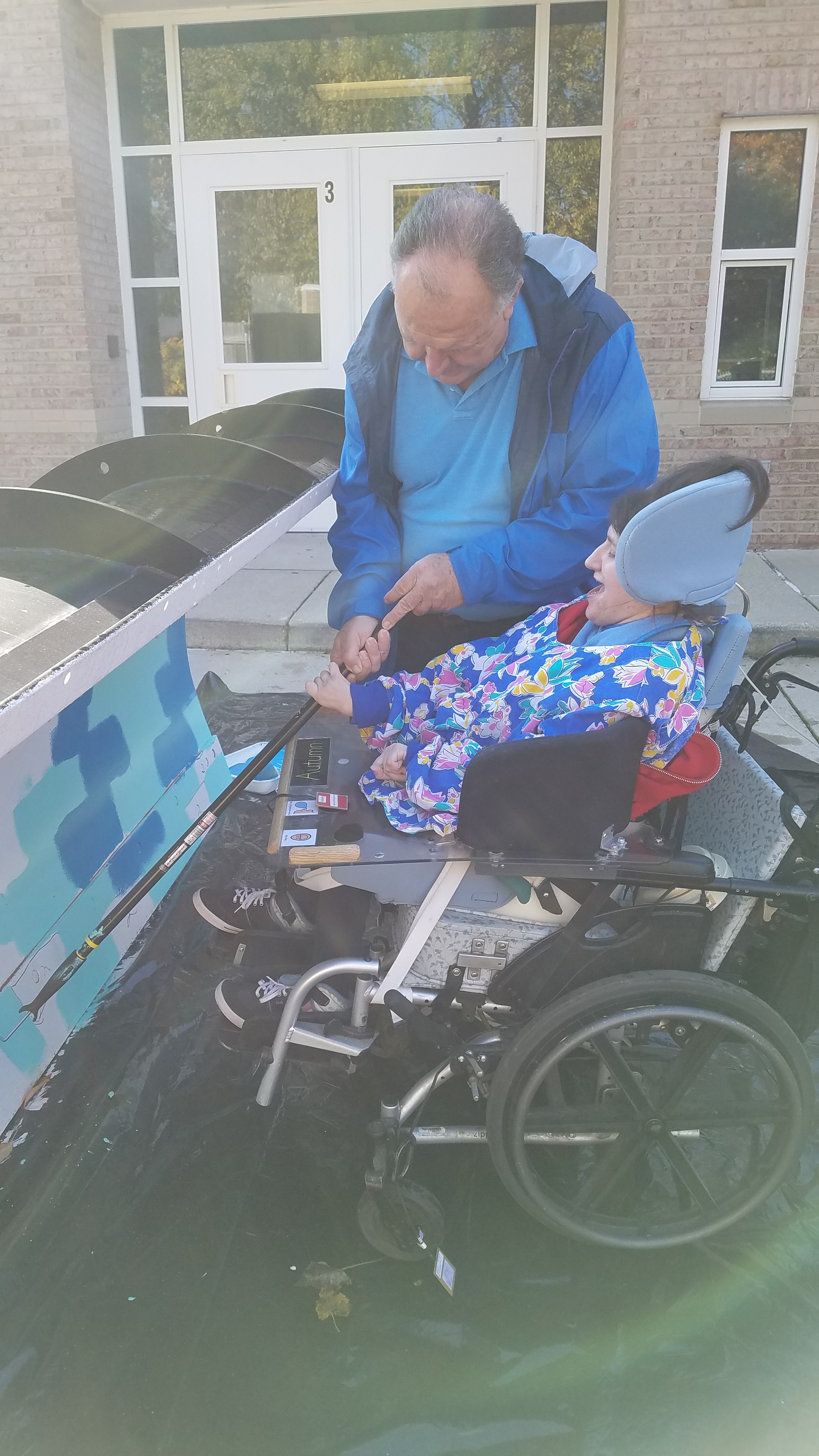 Student Using a Roller to Paint the Plow