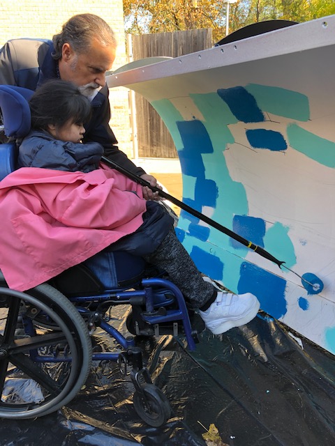 Side View of a Student Painting a Plow