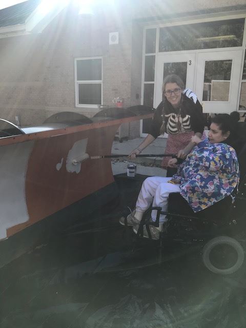 Opposite Side View of a Student Painting a Plow