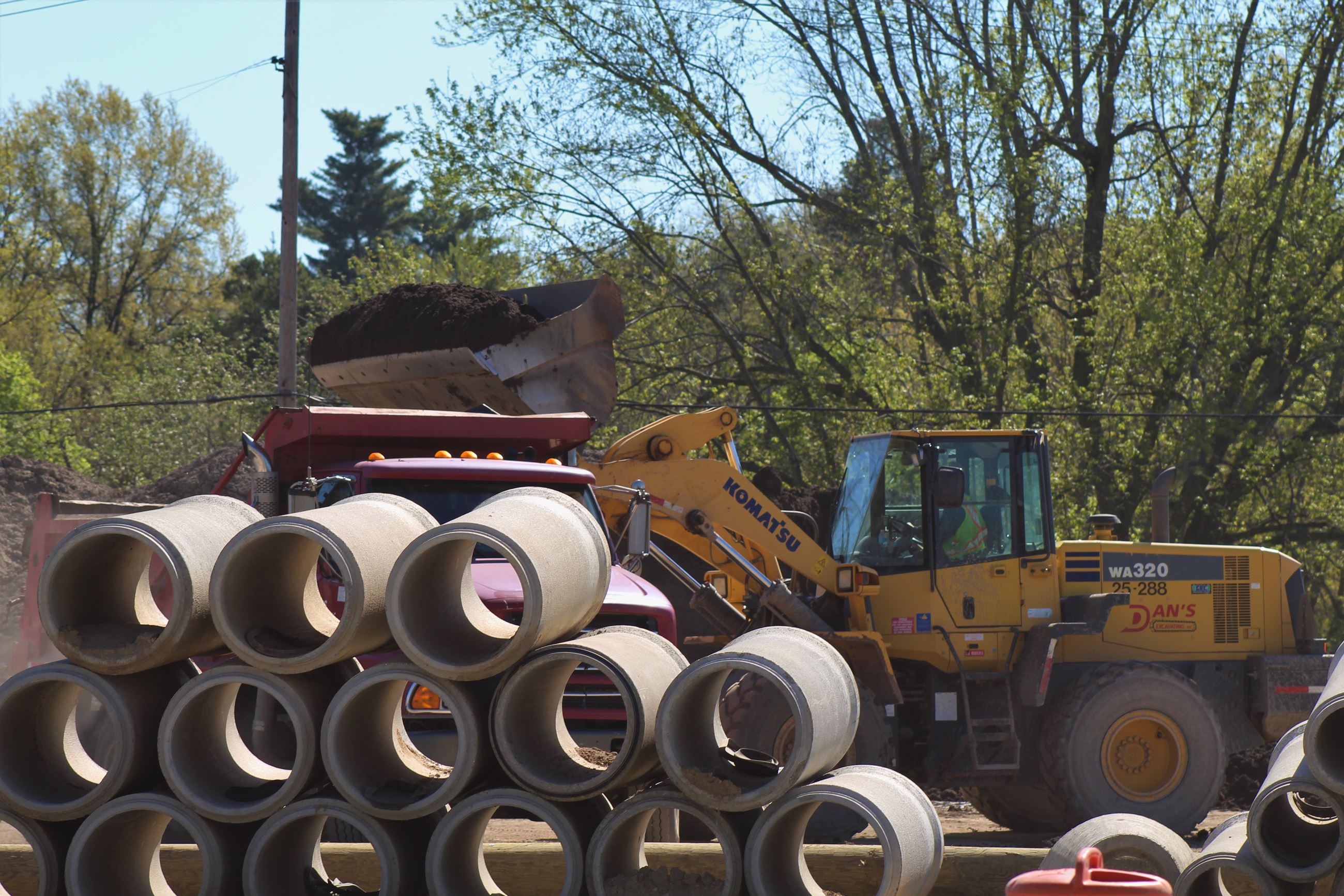 Front Loader Depositing Materials into Dump Truck