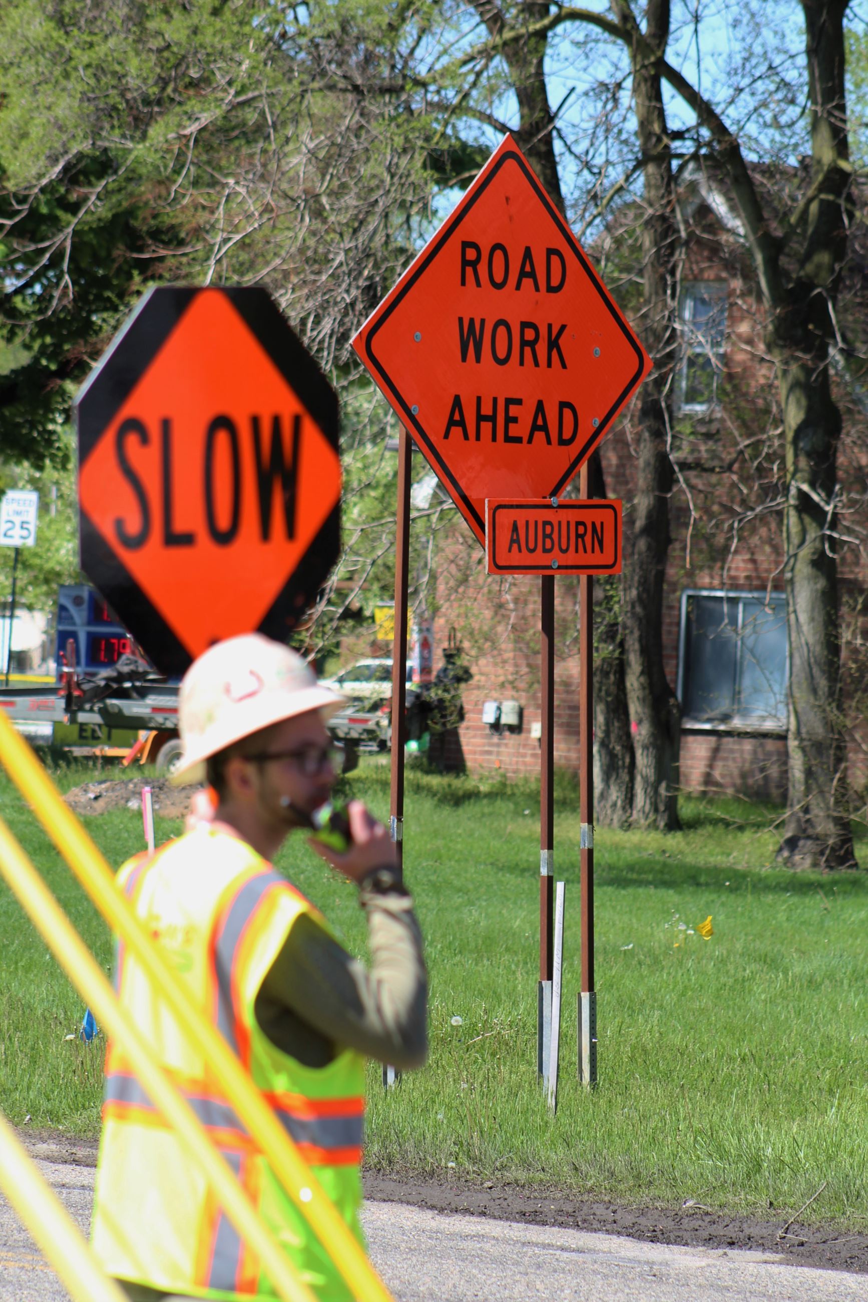 Construction Flagger with Road Work Sign