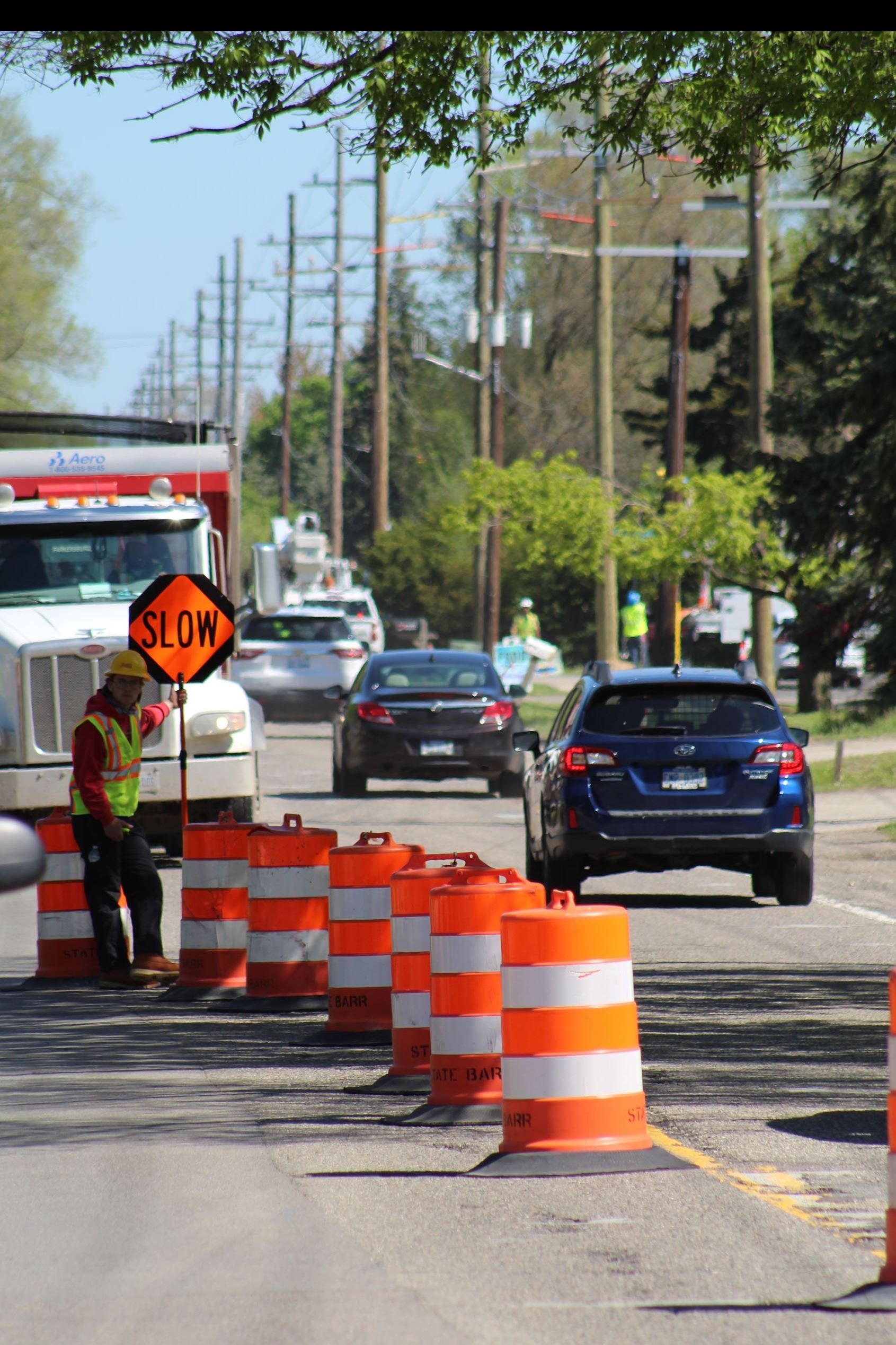Construction Flagger Directing Traffic on Dequindre Road