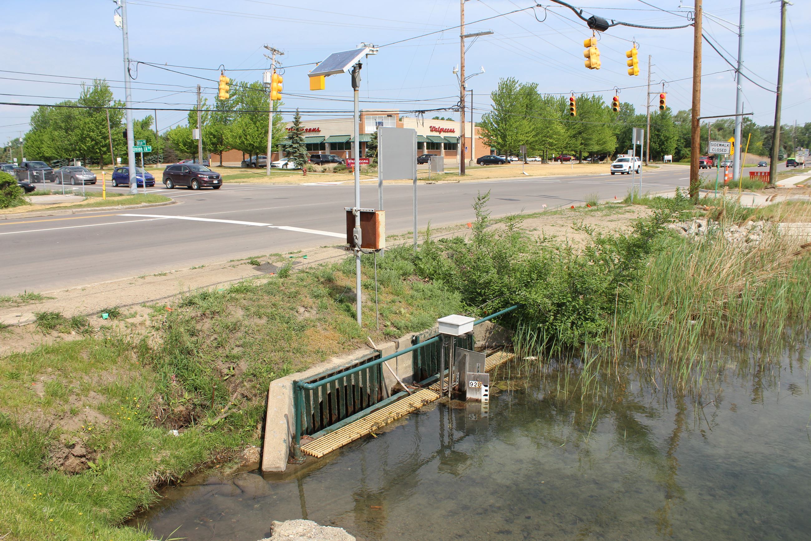 View of the culvert with the Union Lake Rd./Wise Rd. intersection pre-construction behind