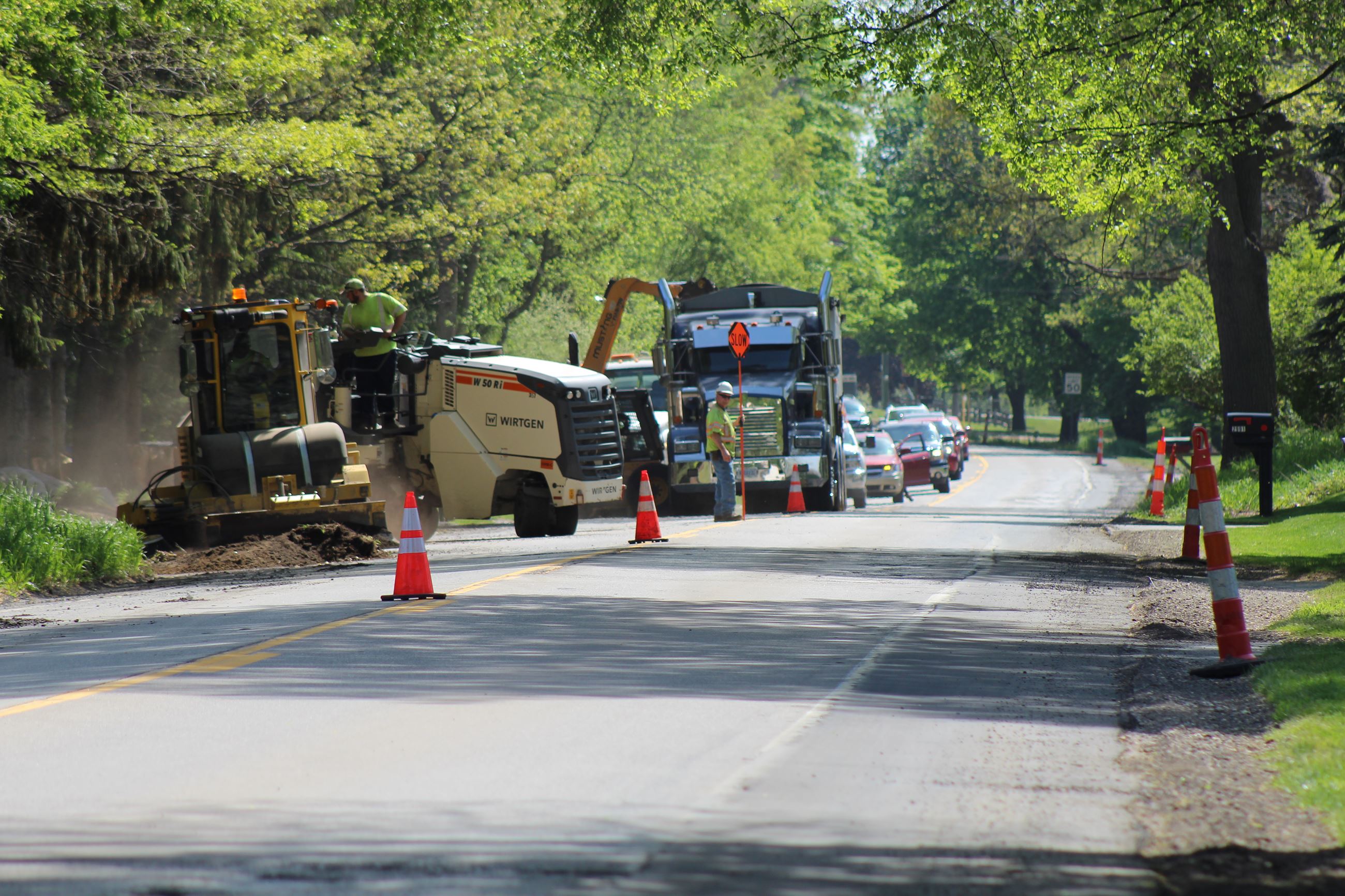 Cleaning up millings on Seymour Lake Rd. ahead of Preservation Overlay paving in Oxford Charter Township 
