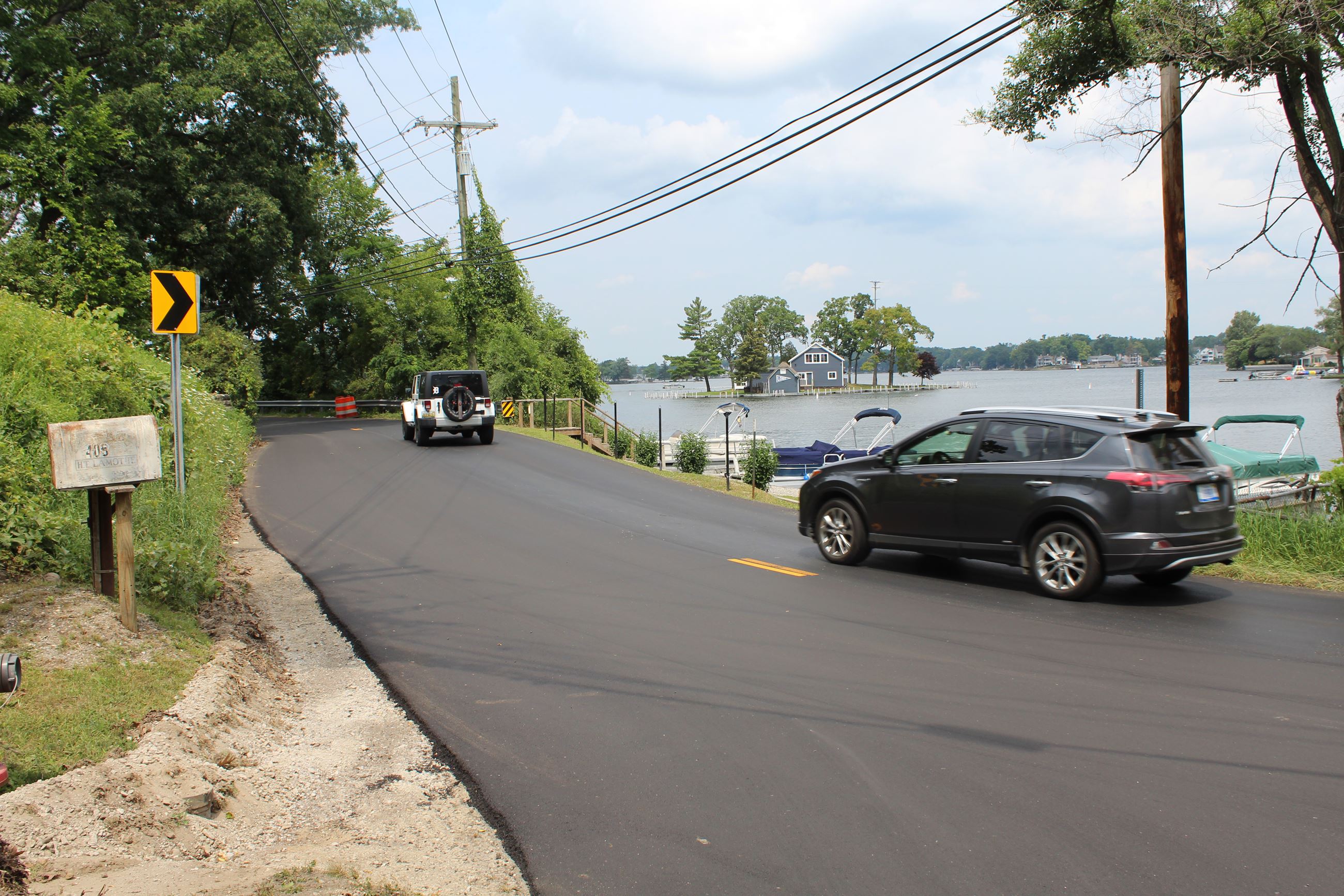 Freshly paves Heights Rd. between Lapeer and Joslyn Rds. with Lake Orion in the background in Orion Township